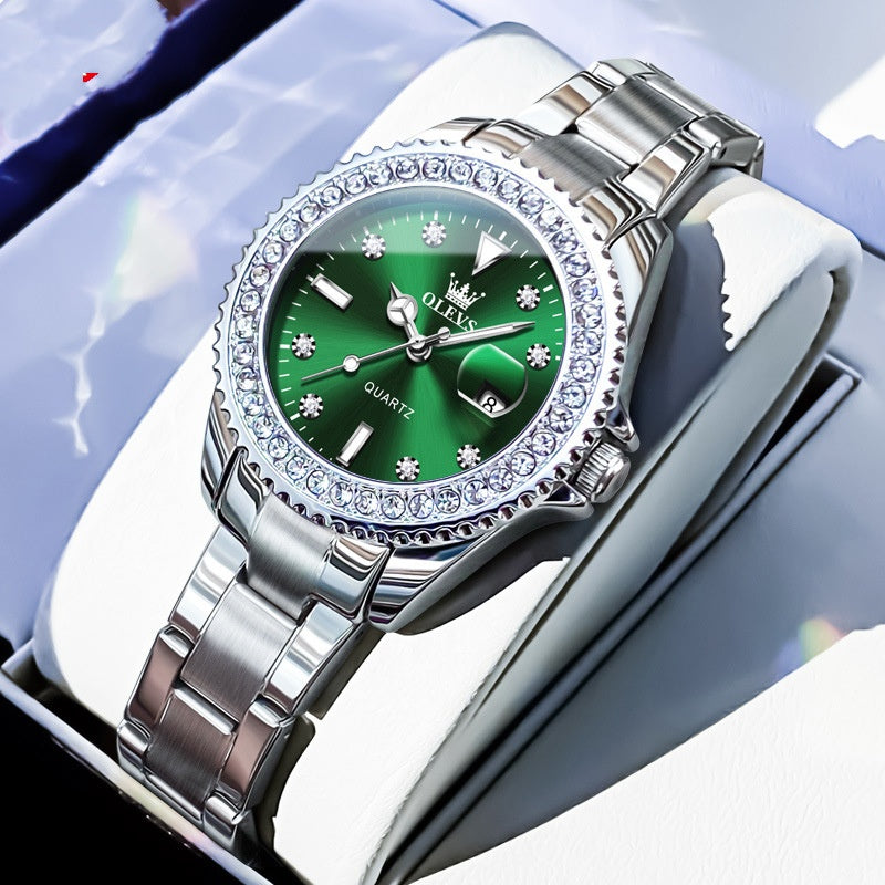 Quartz wristwatch with green dial, crystal bezel, and silver metal link bracelet
