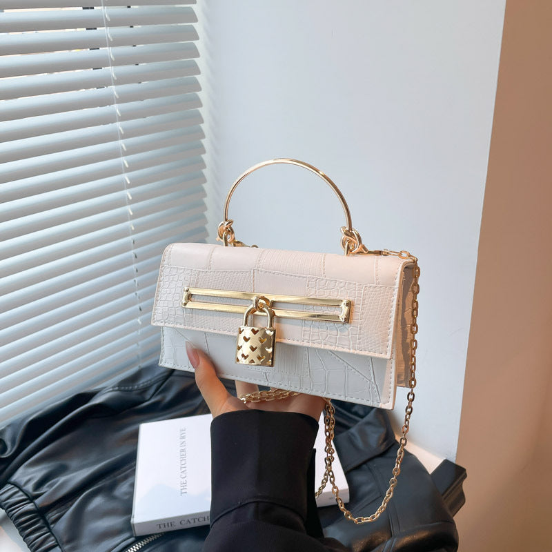 Women’s chain crossbody bag in white PU leather with gold-tone clasp bar and chain strap