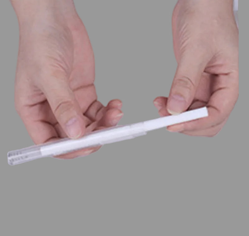 Hands inserting a replacement filter strip into a USB humidifier