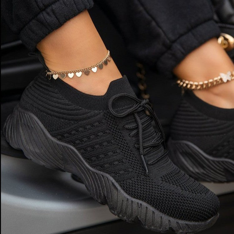 Black thick-sole dad sneakers with lace-up front and chunky textured outsole