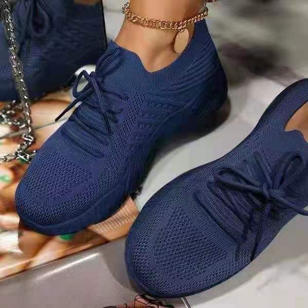 Navy blue thick-sole dad sneakers with lace-up design and textured knit upper
