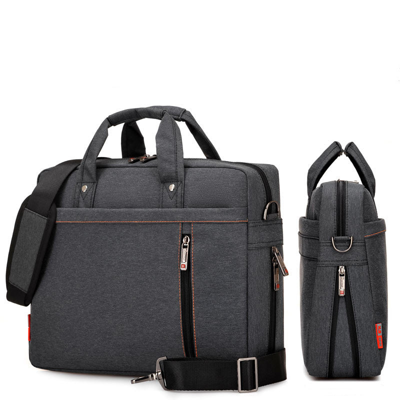 Dark grey waterproof laptop bag with front zip panel, side pocket, and adjustable strap