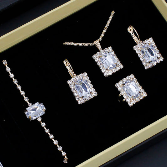 Jewelry set with square gemstones on a black background