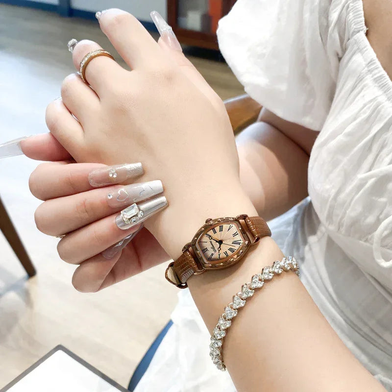 Women’s brown leather strap watch with rose gold Roman dial on wrist