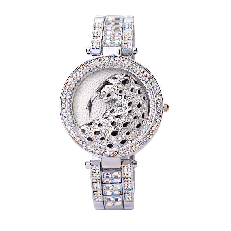 Silver wristwatch with intricate design on a white background