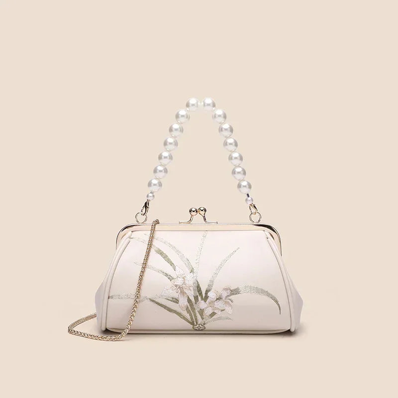 Beige embroidered shoulder bag with beaded top handle and floral front