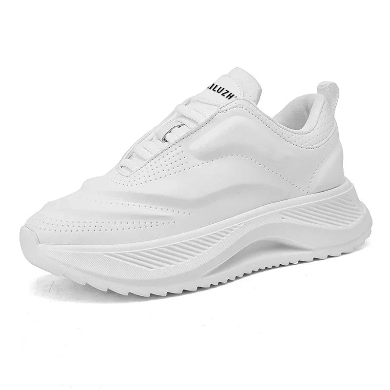 White low-top lace-up sneaker with thick sole, side ridges, and perforated toe panel