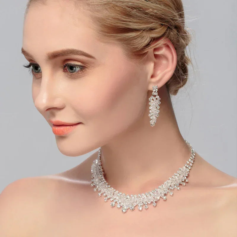 Bridal rhinestone necklace with matching dangling drop earrings on model