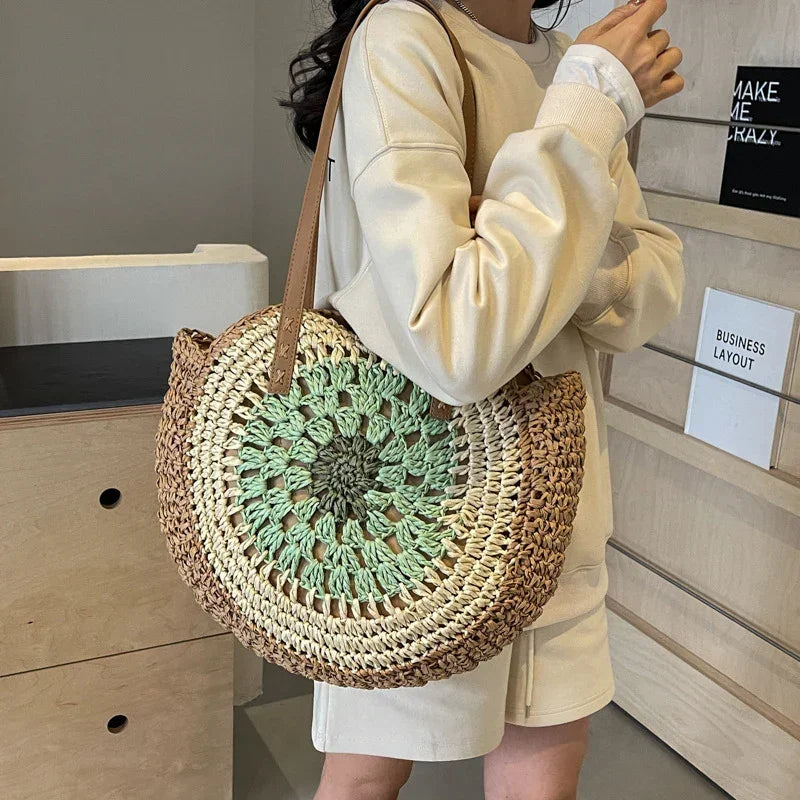 Crochet straw tote bag with mint green round floral center and brown leather handles