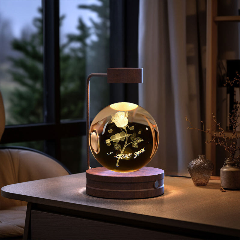 Crystal ball LED night light glowing globe on round wood base with lighted motifs