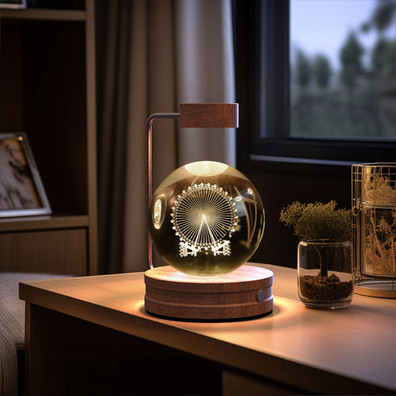 Crystal ball LED night light with circular sunburst pattern inside glowing globe on wood base