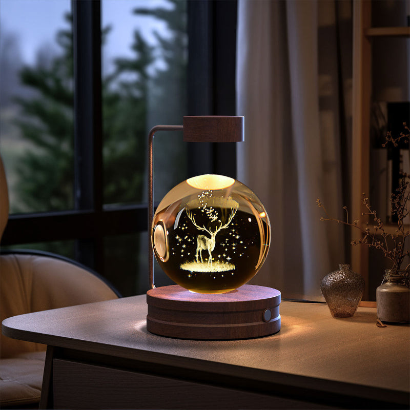 Crystal ball LED night light with starry landscape and small tree silhouettes inside globe
