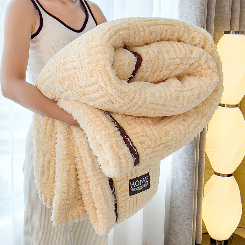 Cream plush velvet blanket with textured pattern, dark edge trim, and folded roll layers