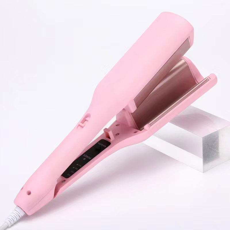 Deep wave curling iron in pink with open clamp and long barrel for curls