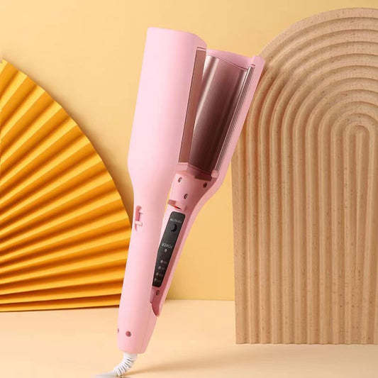 Pink hair straightener on a yellow background