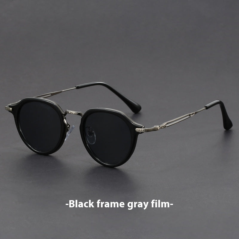 Unisex round metal sunglasses with black frames and dark lenses