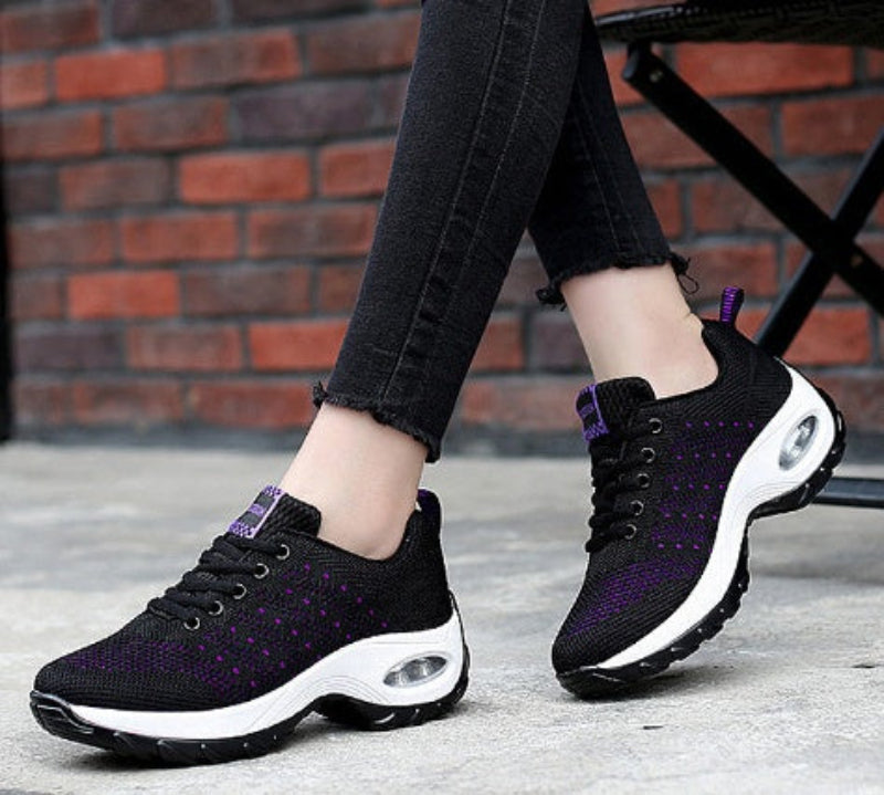 Black knit walking sneakers with purple speckle accents and white air-cushion sole