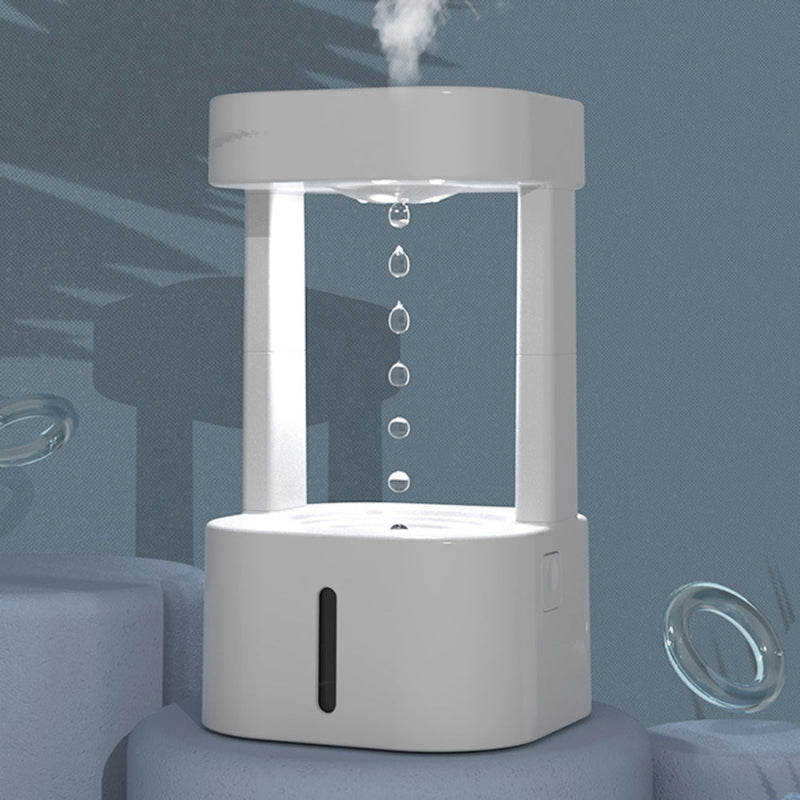 White anti-gravity water drop humidifier releasing mist with stacked droplet stream