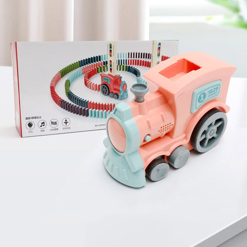 Domino train car toy with colorful track pieces and pink-and-teal locomotive