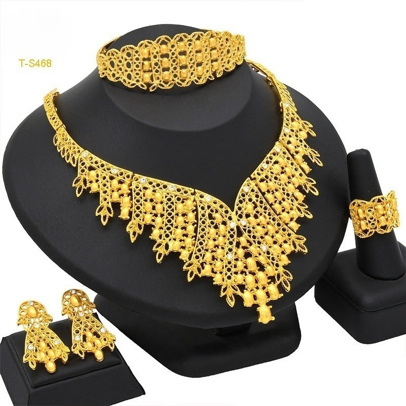 Gold-tone four-piece jewelry set with ornate fringe collar necklace, matching earrings and bracelet