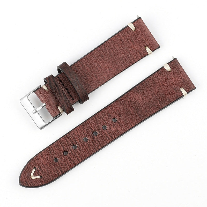 Burgundy patterned leather watch strap with silver buckle and perforated adjustment holes