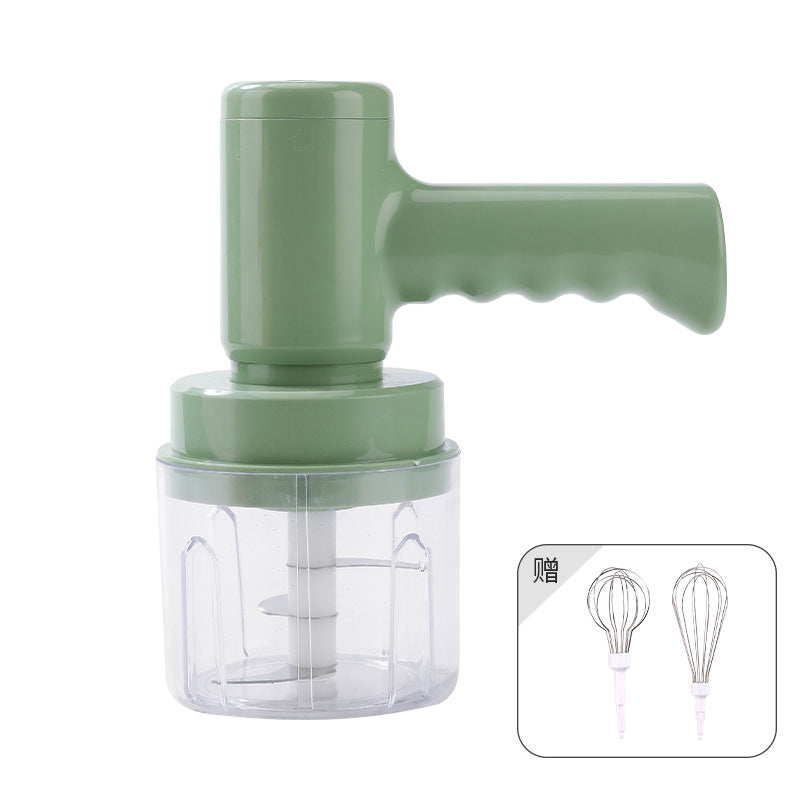 Electric whisk hand blender with green motor unit, clear cup, and included wire whisk attachments