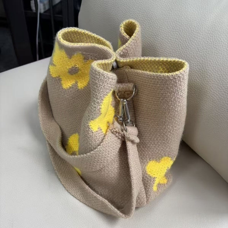 Beige hand-crocheted tote bag with yellow flower appliques and metal clasp