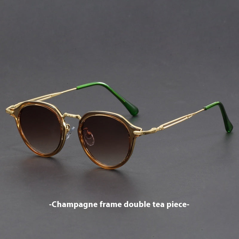 Unisex round metal sunglasses with champagne frames, green temple tips, dark lenses