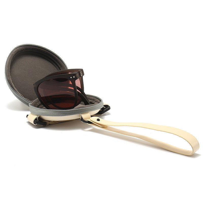 Dark brown polarized folding sunglasses with rectangular lenses and open storage case
