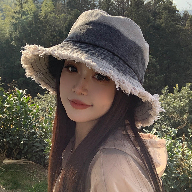 Black denim bucket hat with frayed wide brim and structured stitched crown