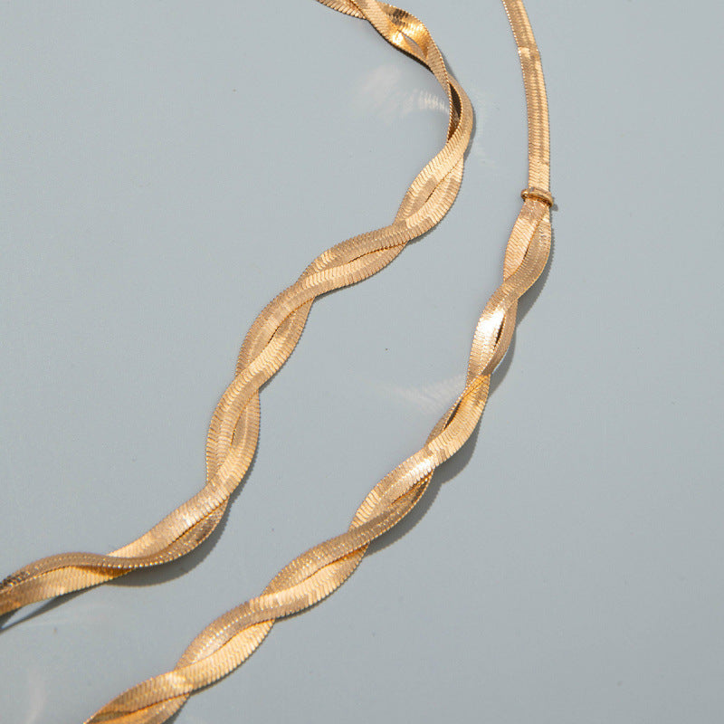Gold snake-chain belt with twisted, braided links in a continuous loop