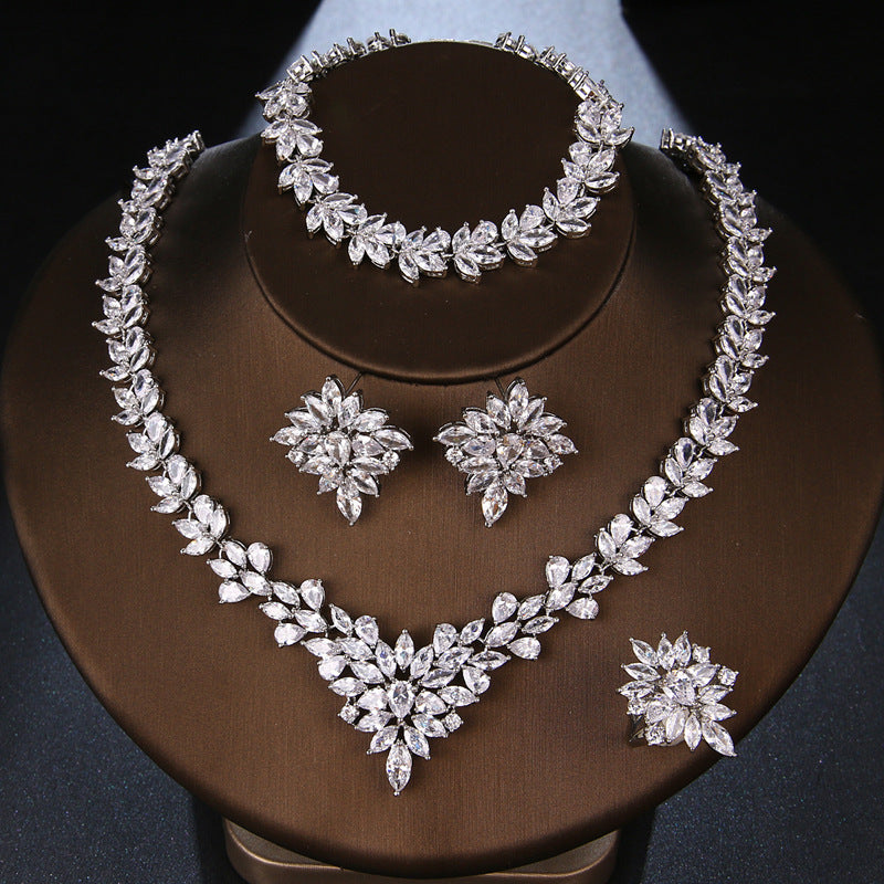 Silver zircon floral necklace with matching bracelet, two drop earrings, and ring