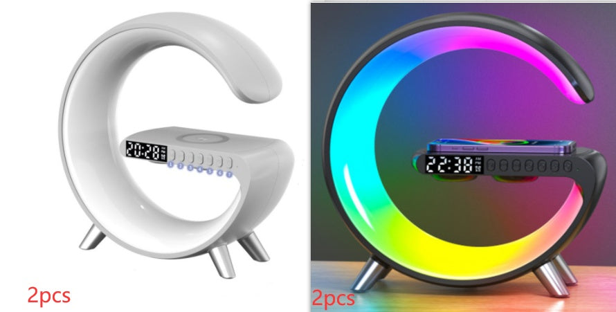 White and black G-shaped LED lamps with digital clocks and wireless charging pads
