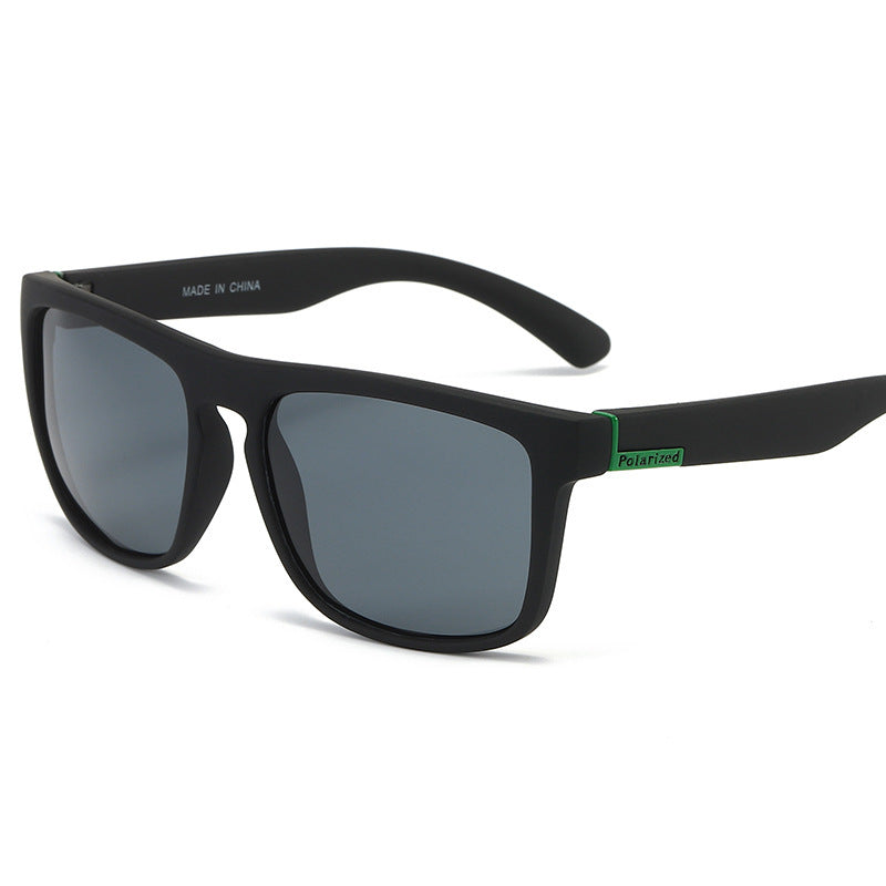 Polarized sports sunglasses with matte black frame and dark square lenses, green accent