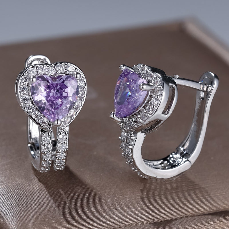 Heart-shaped clip earrings with purple center stones and pavé silver setting