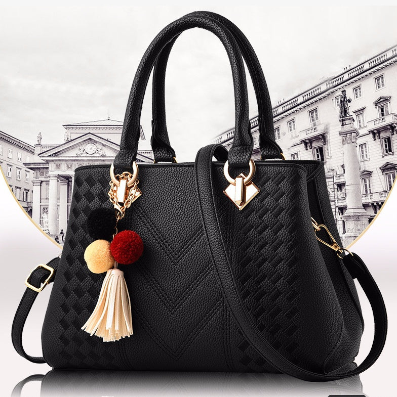 Women's crossbody handbag, black PU leather with textured pattern and tassel charm