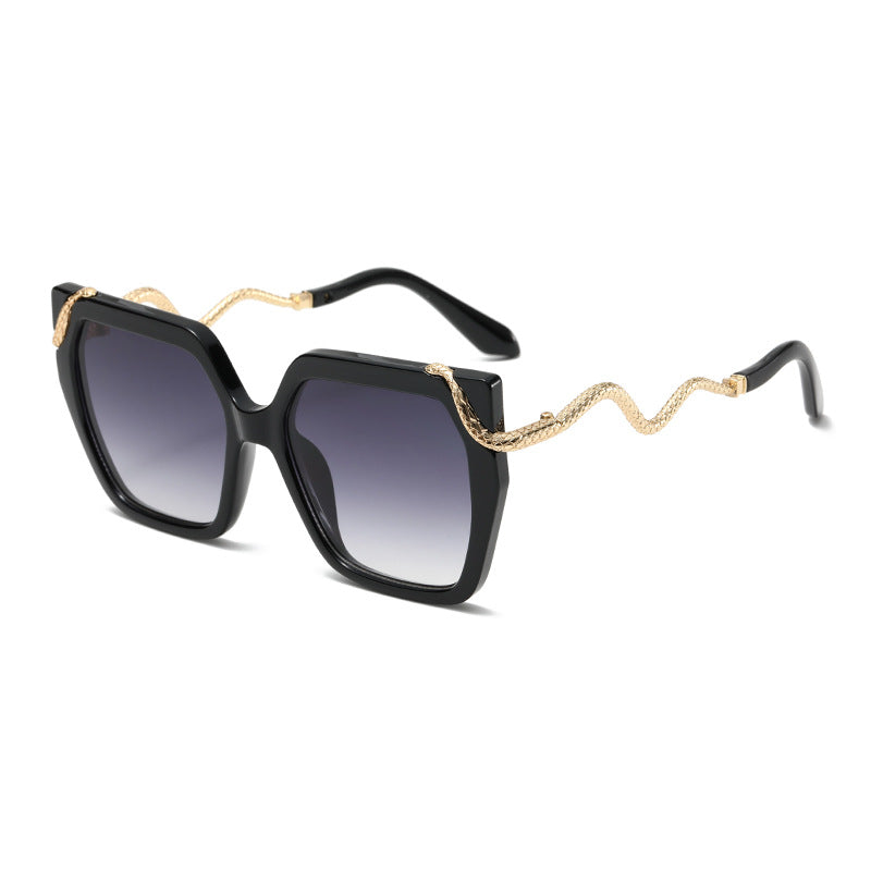 Square black sunglasses with dark lenses and gold snake temple arms