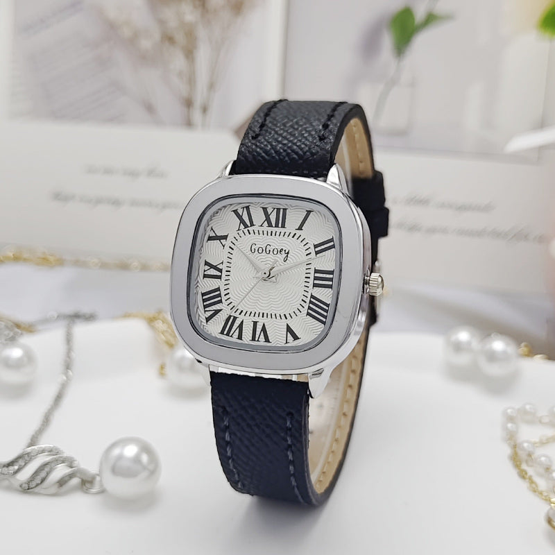 Women’s retro Roman dial leather strap watch with silver case and navy leather strap.