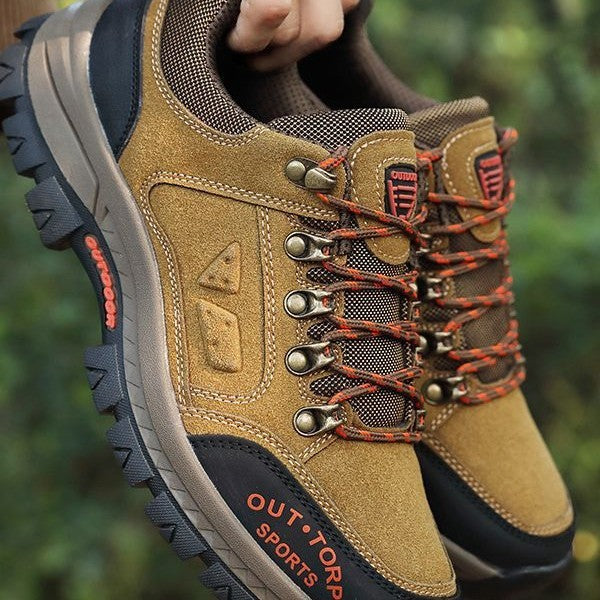 Khaki hiking shoe with rugged tread, lace-up design, padded collar, orange accents
