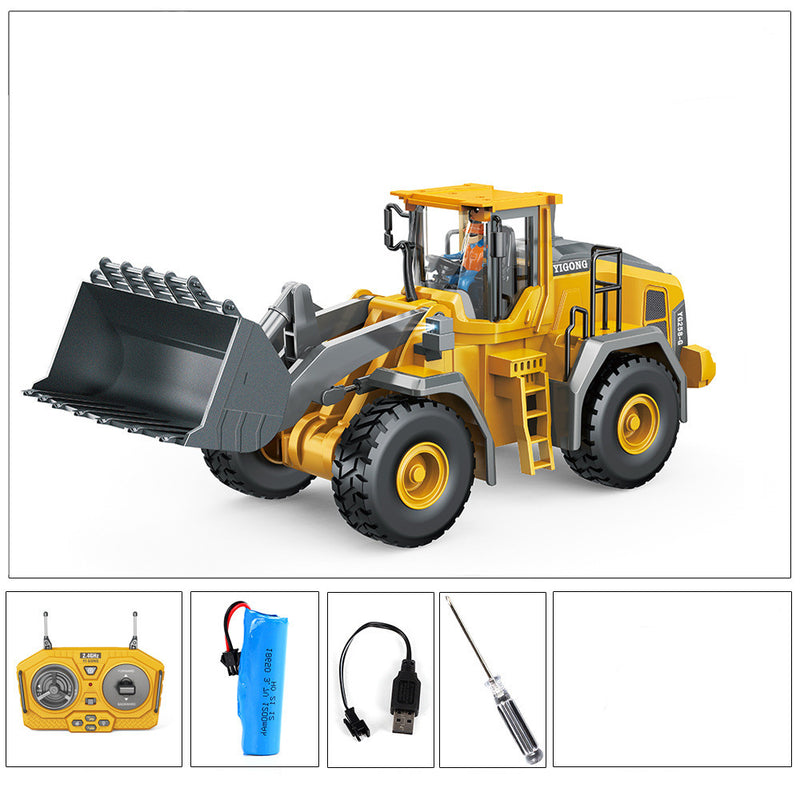 Yellow RC excavator toy with front bucket and cab, plus remote control and parts