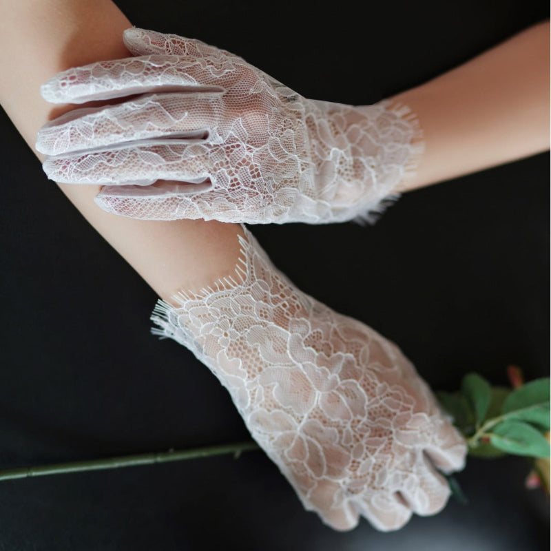 White lace tulle bridal gloves with layered ruffle lace trim and floral embroidery