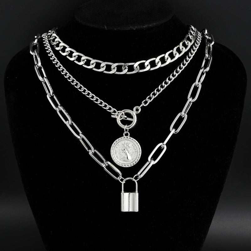 Silver-tone layered chain necklace set with round medallion and padlock pendant