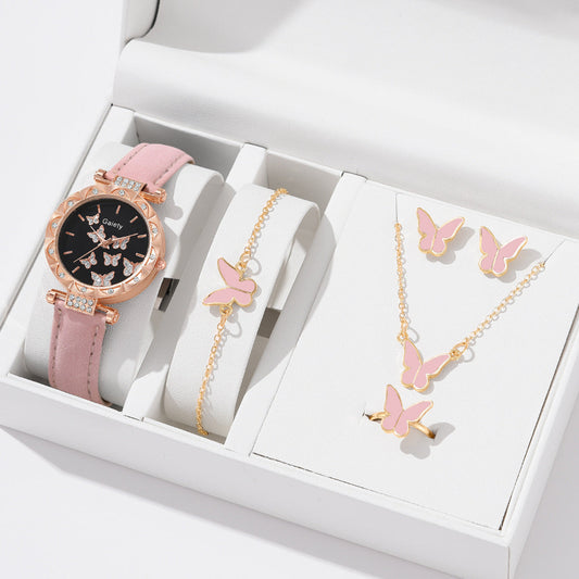 Pink watch, bracelet, and necklace set with butterfly designs in a white box.