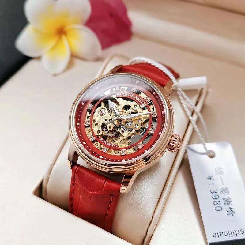 Red leather-strap mechanical watch with rose-gold case and diamond-accent bezel