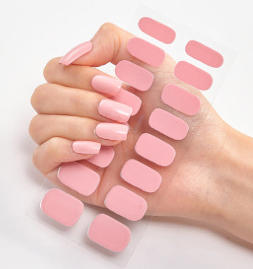 Nail sticker wraps set with soft pink press-on style nails on clear sheet