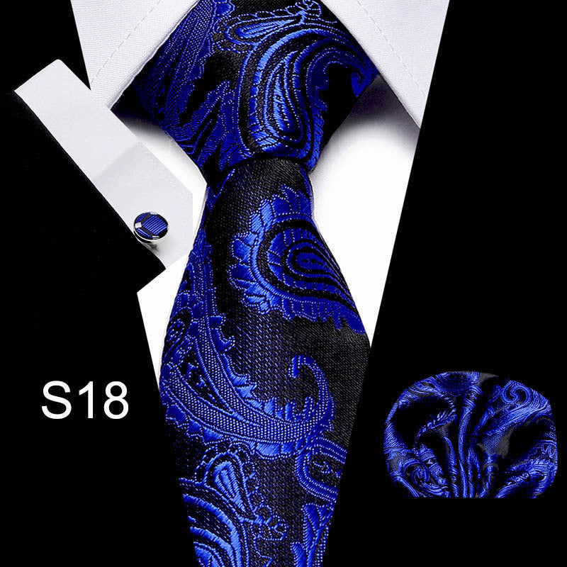 Men's business tie in dark blue with ornate swirling paisley pattern
