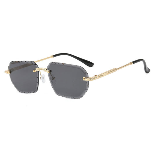 Sunglasses with gold frame and black arms on a white background