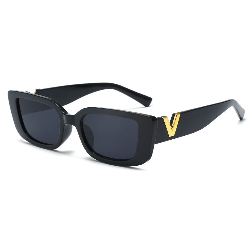 Square black frame sunglasses with gray-blue lenses and gold V temple detail