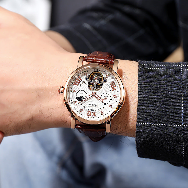 Mechanical watch worn on wrist with rose-gold case, white dial, brown leather strap