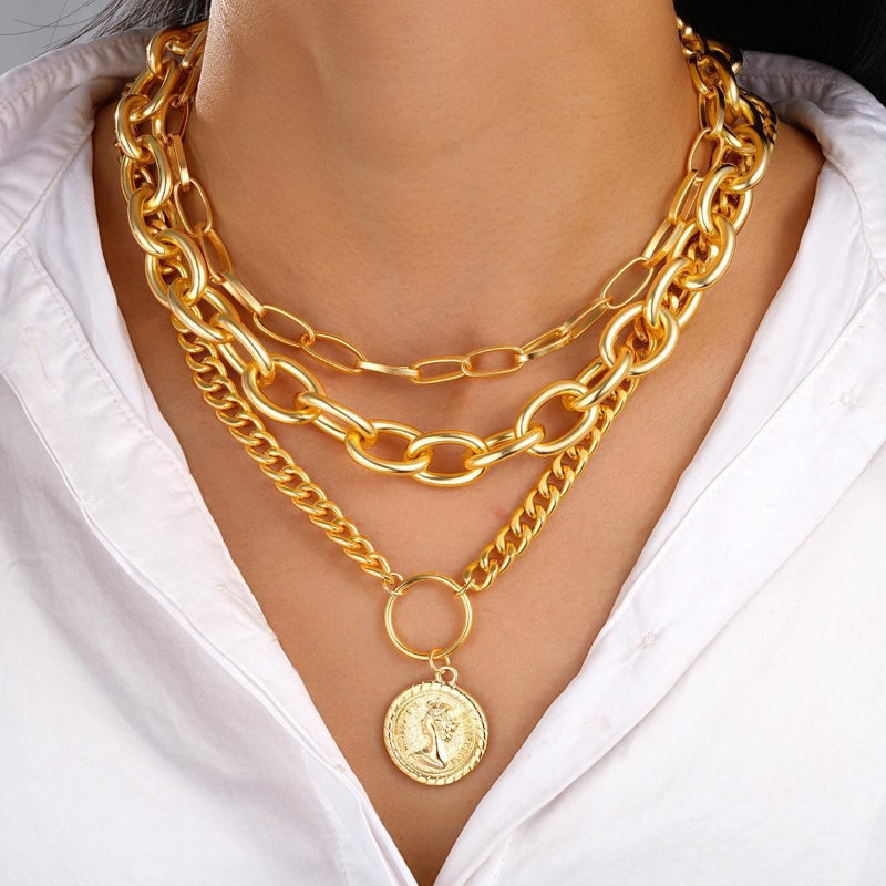 Gold-tone layered chain necklace set with medallion pendant and round ring charm